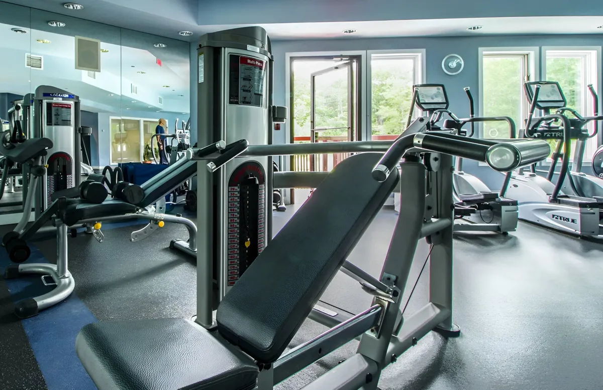 This bright fitness center features large windows that flood the space with natural light, modern exercise equipment, and mirrored walls. The inviting atmosphere is perfect for maintaining fitness routines or recovering after a day on the trails.